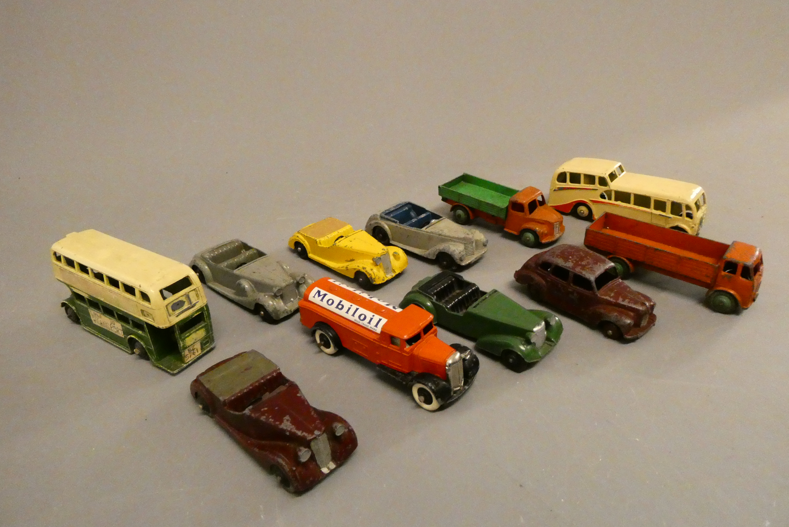Eleven early Dinky cars including saloons, bus and wagons, poor (Est. plus 24% buyer's premium inc. Image