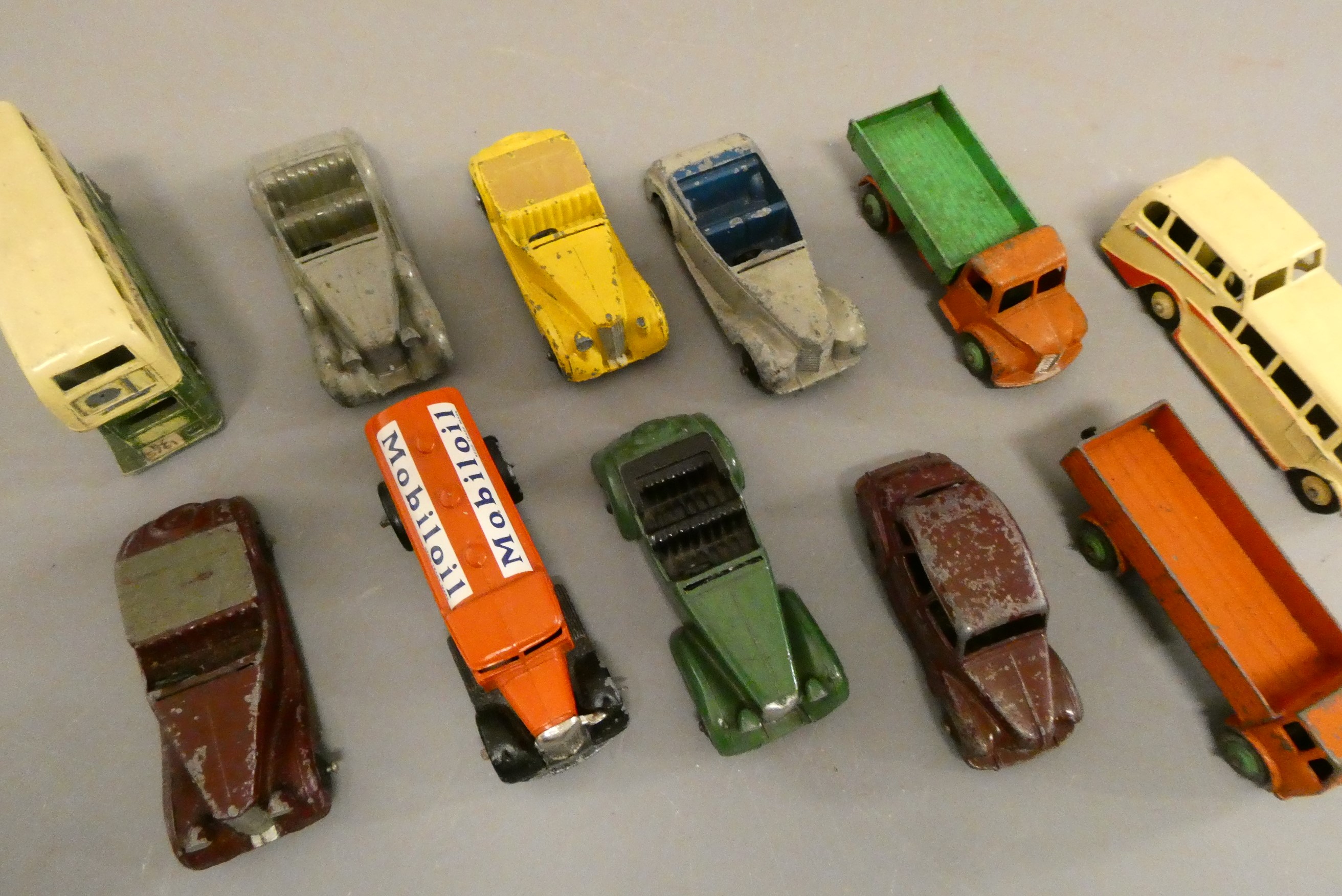 Eleven early Dinky cars including saloons, bus and wagons, poor (Est. plus 24% buyer's premium inc. Image