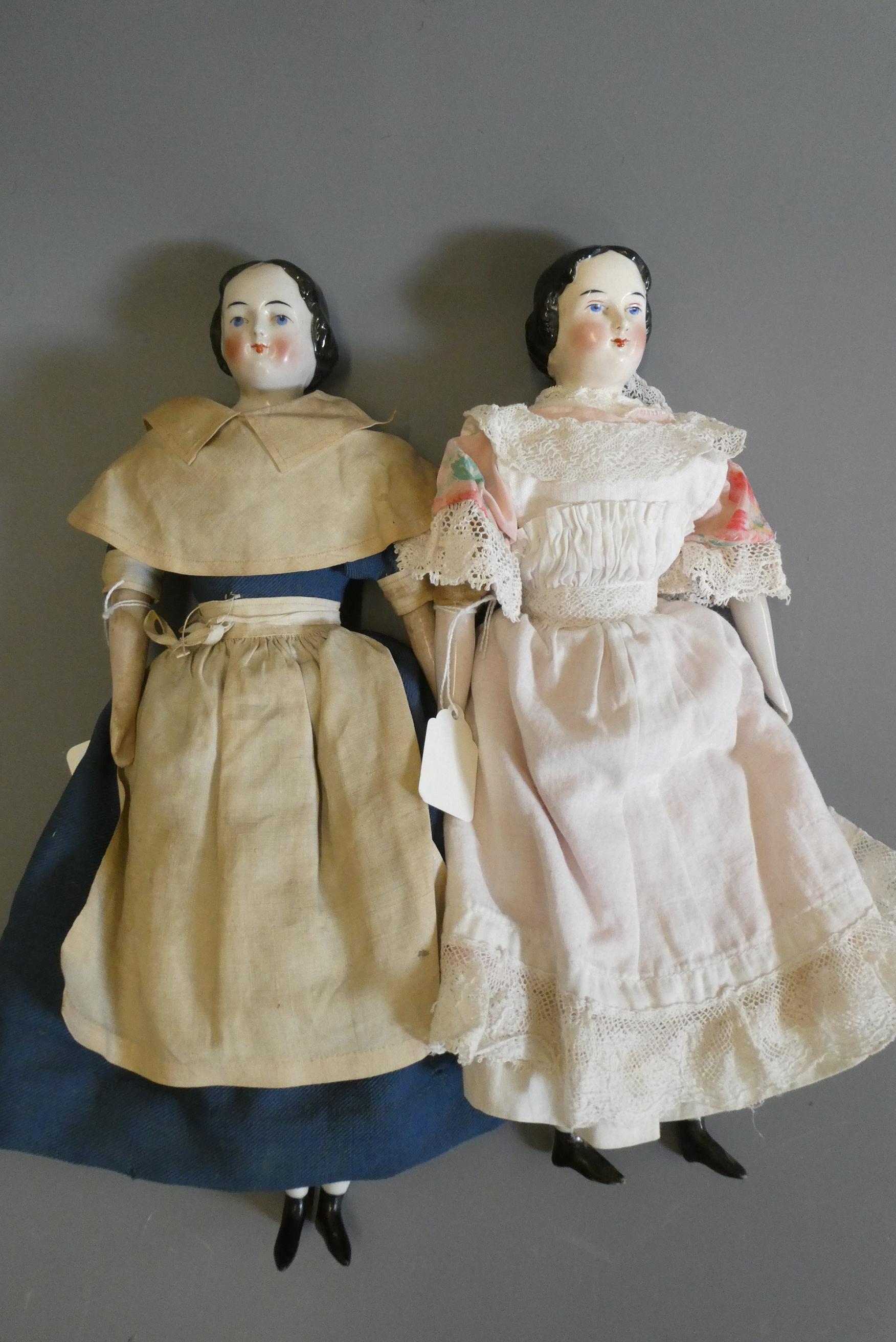 Two Victorian china shoulder head doll's, with painted faces, moulded hair, fabric bodies, china Image