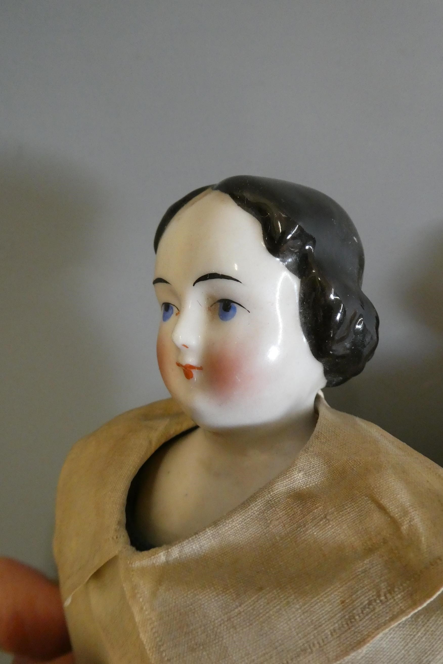 Two Victorian china shoulder head doll's, with painted faces, moulded hair, fabric bodies, china Image