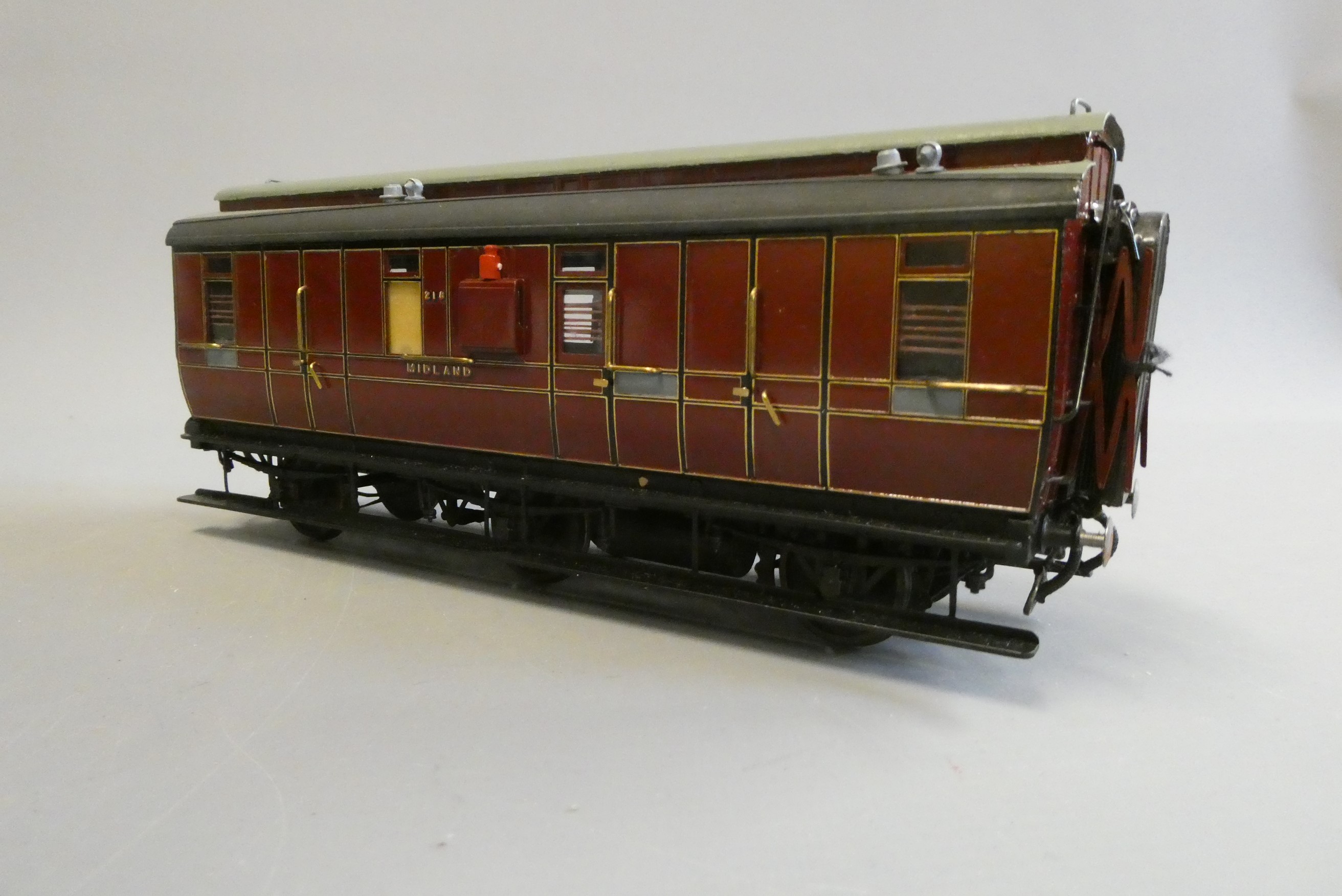 A well-made and finished 7mm 0 gauge model of a Midland Railway six wheeled corridor break coach Image