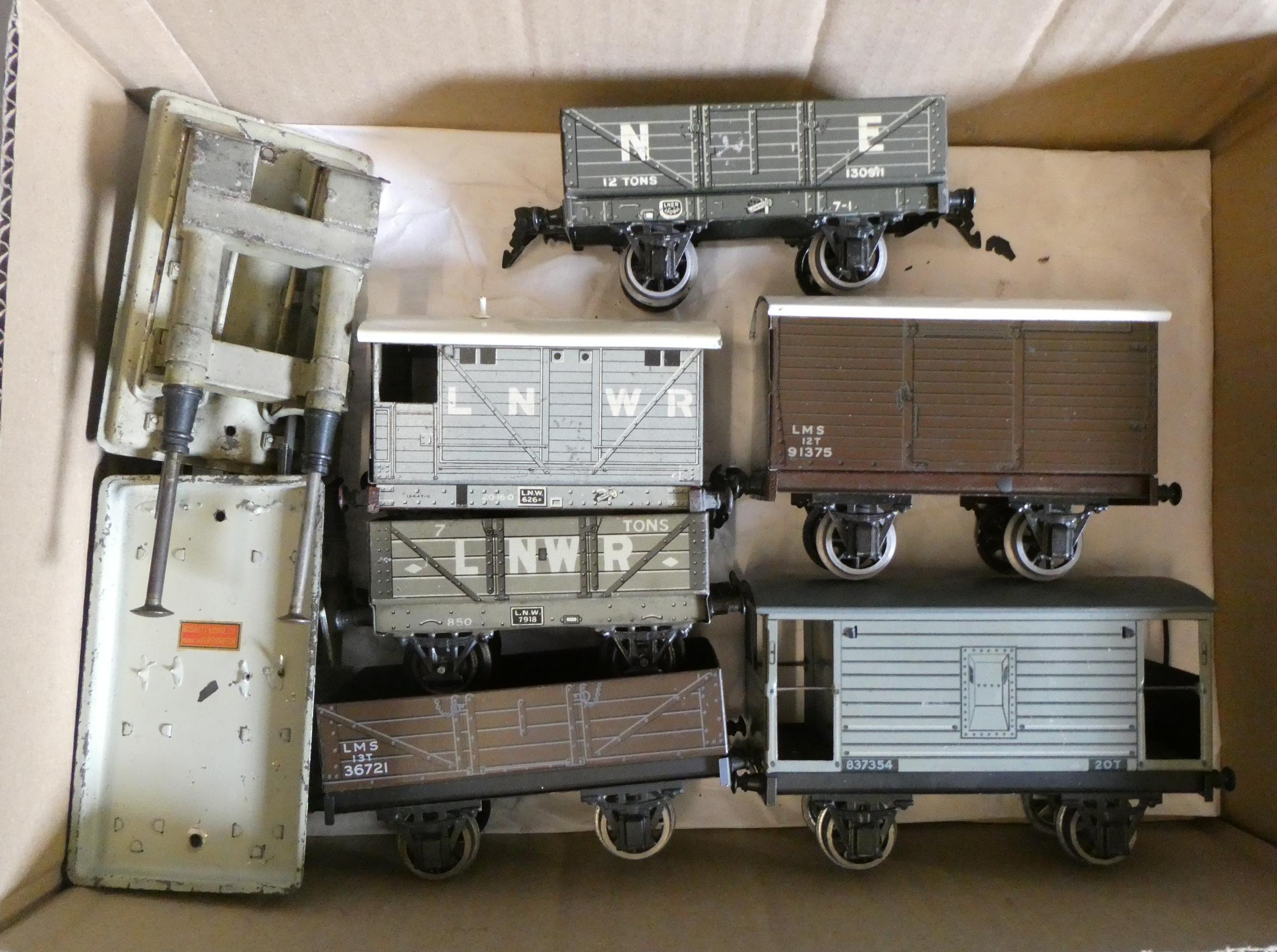 Six Bassett-Lowke tinplate goods trucks including coal wagons and brake vans and two hydraulic Image