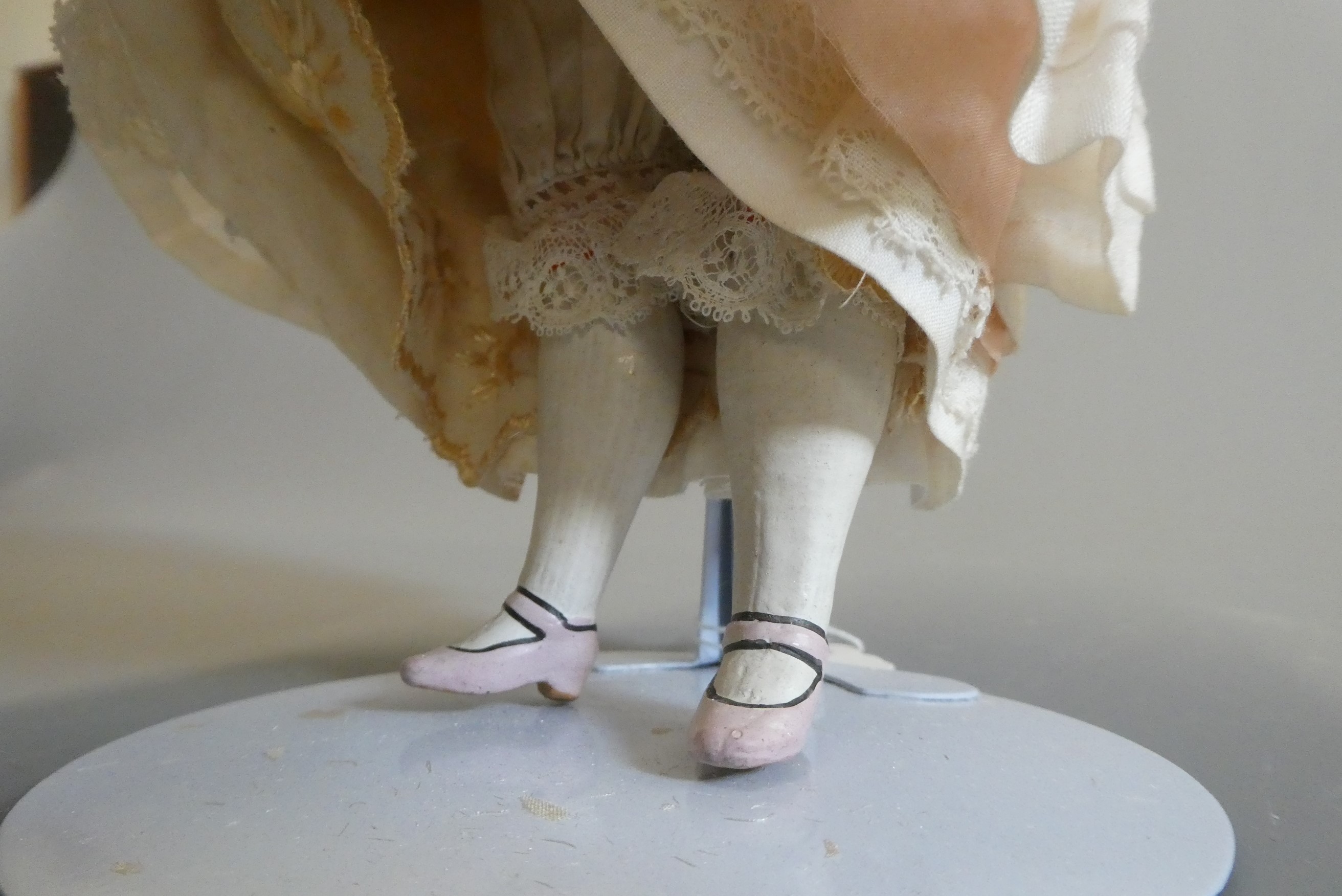 A late Victorian wax shoulder head doll, with blue glass fixed eyes, closed mouth, blond wig, fabric Image