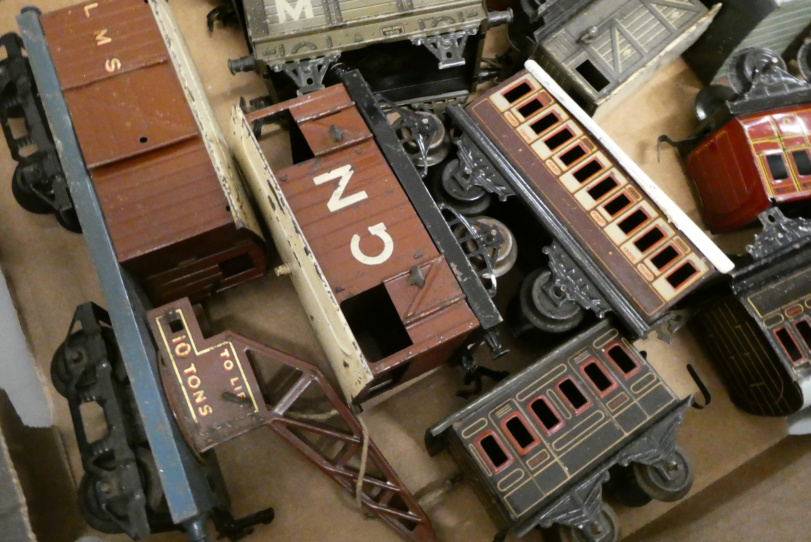 Hornby Clockwork 0-4-0 locomotive with a quantity of tinplate wagons and coaches by Hornby and Image