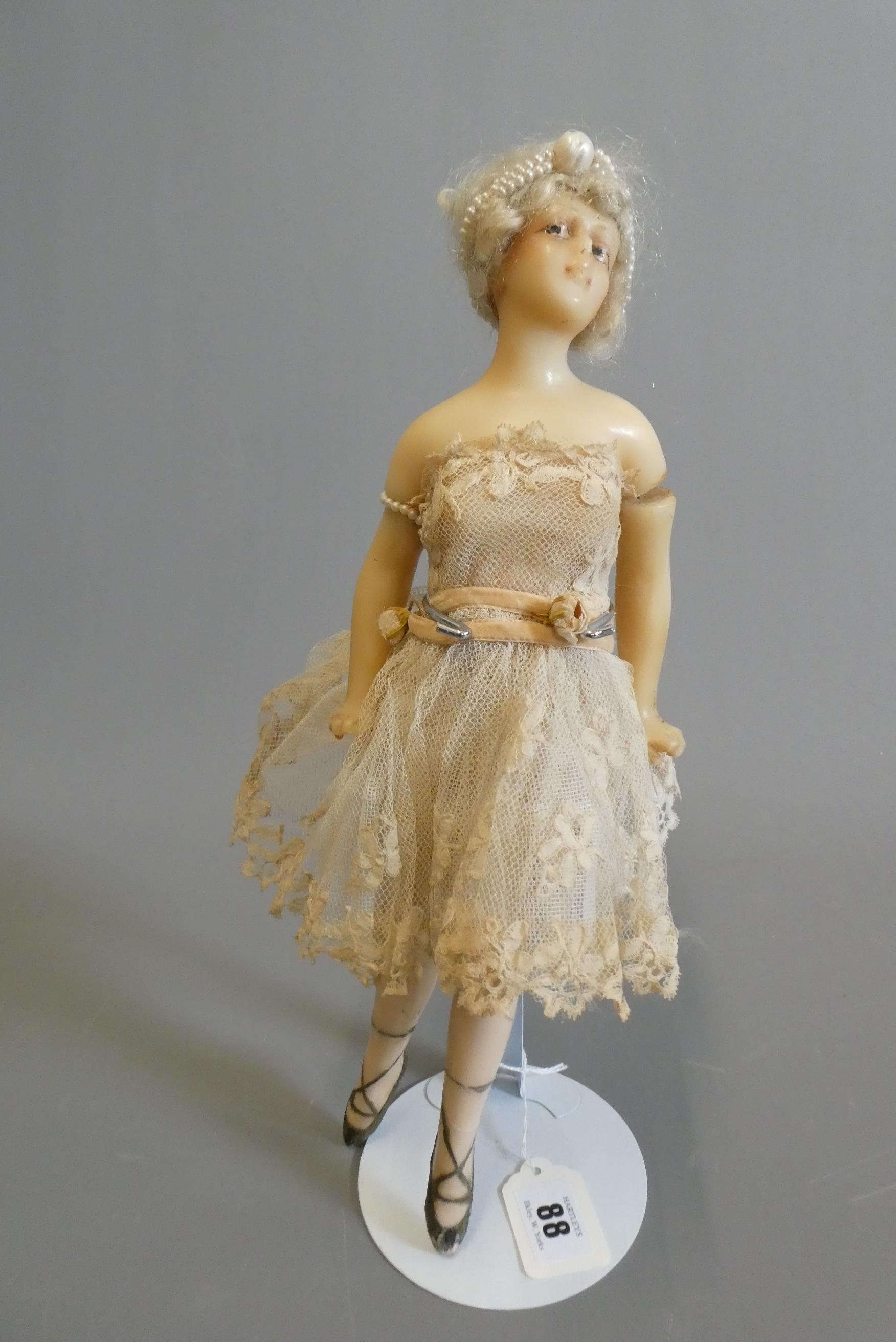An early 20th century all wax ballerina doll, with moulded features, blond wig, wire joined arms, Image