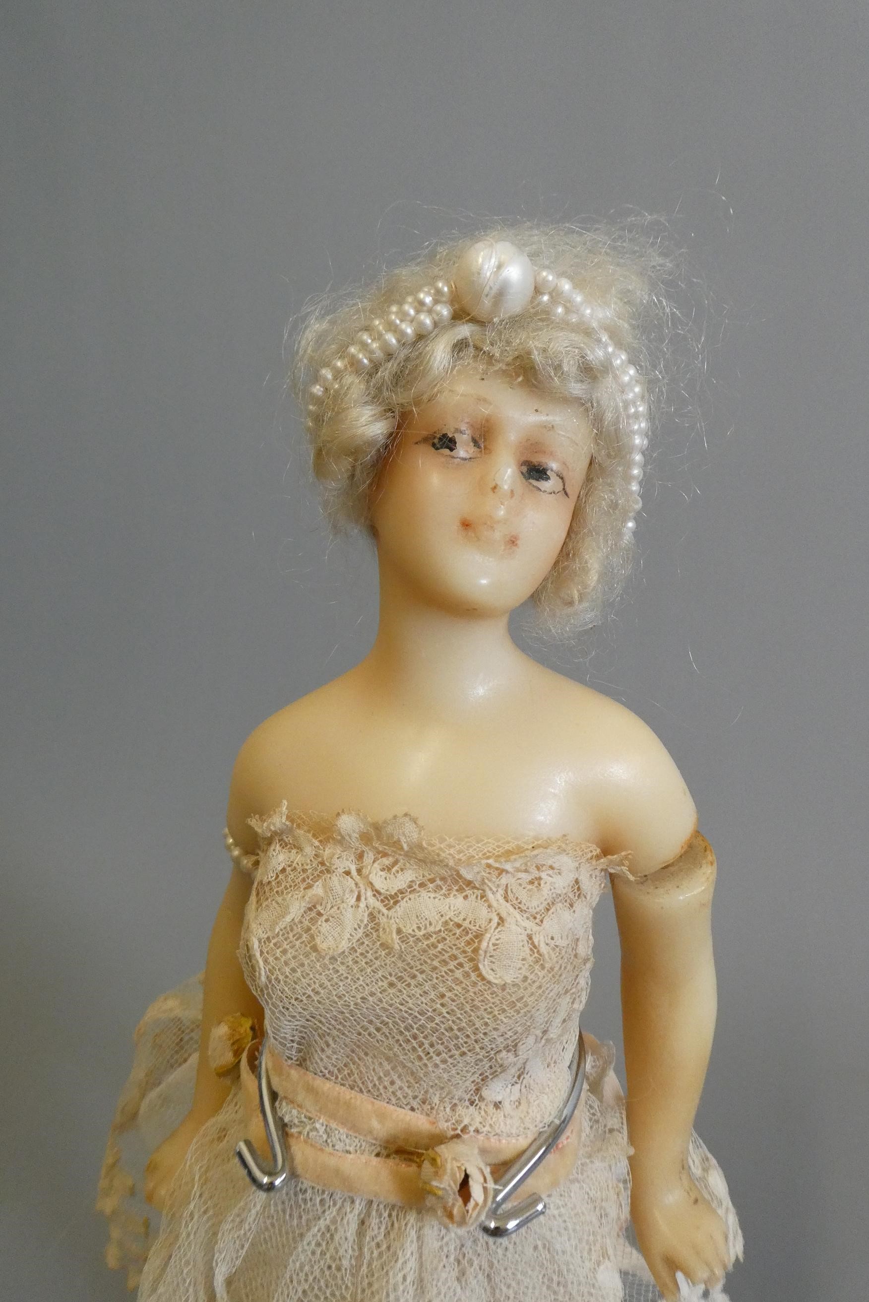 An early 20th century all wax ballerina doll, with moulded features, blond wig, wire joined arms, Image