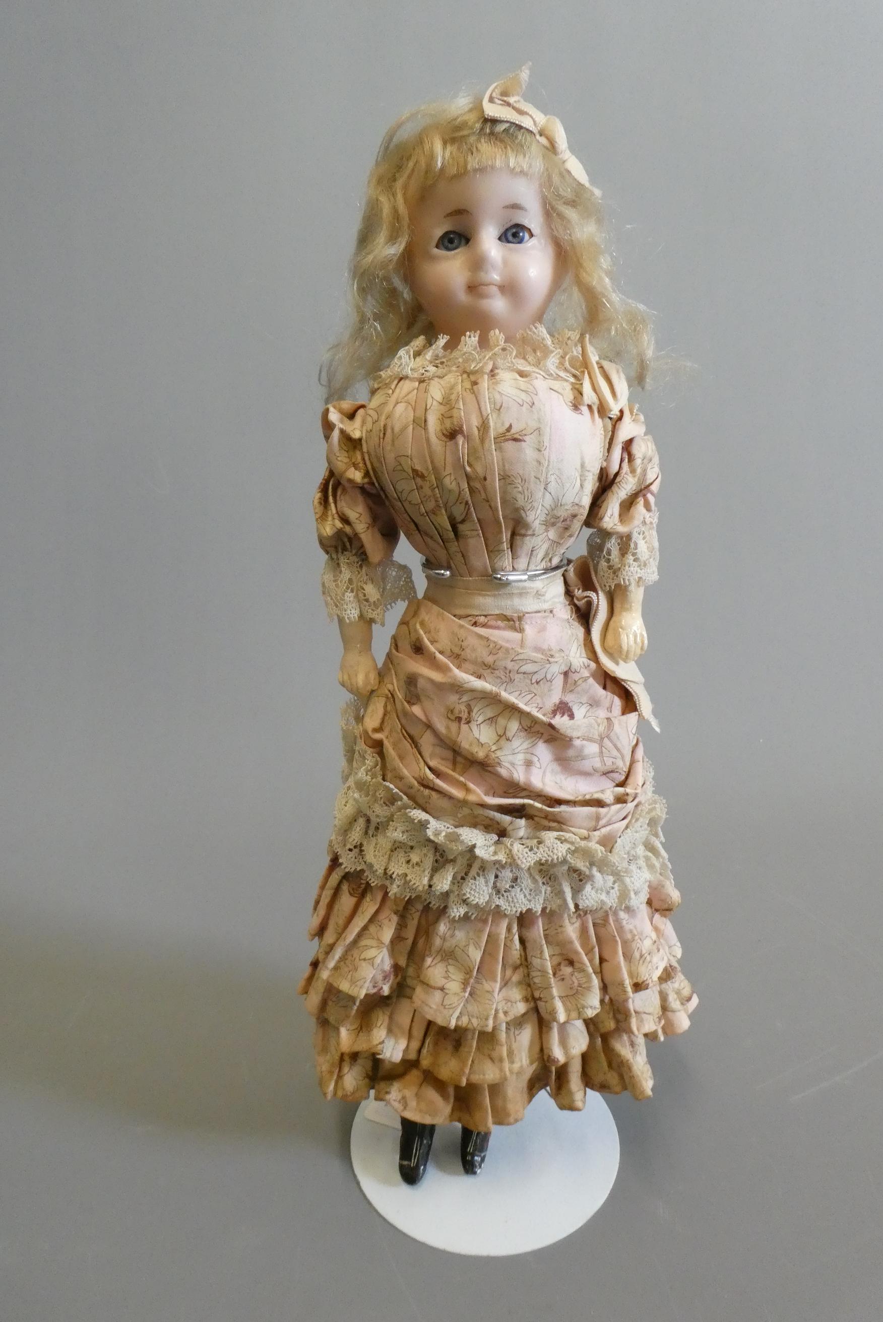 A Victorian wax shoulder head doll Image