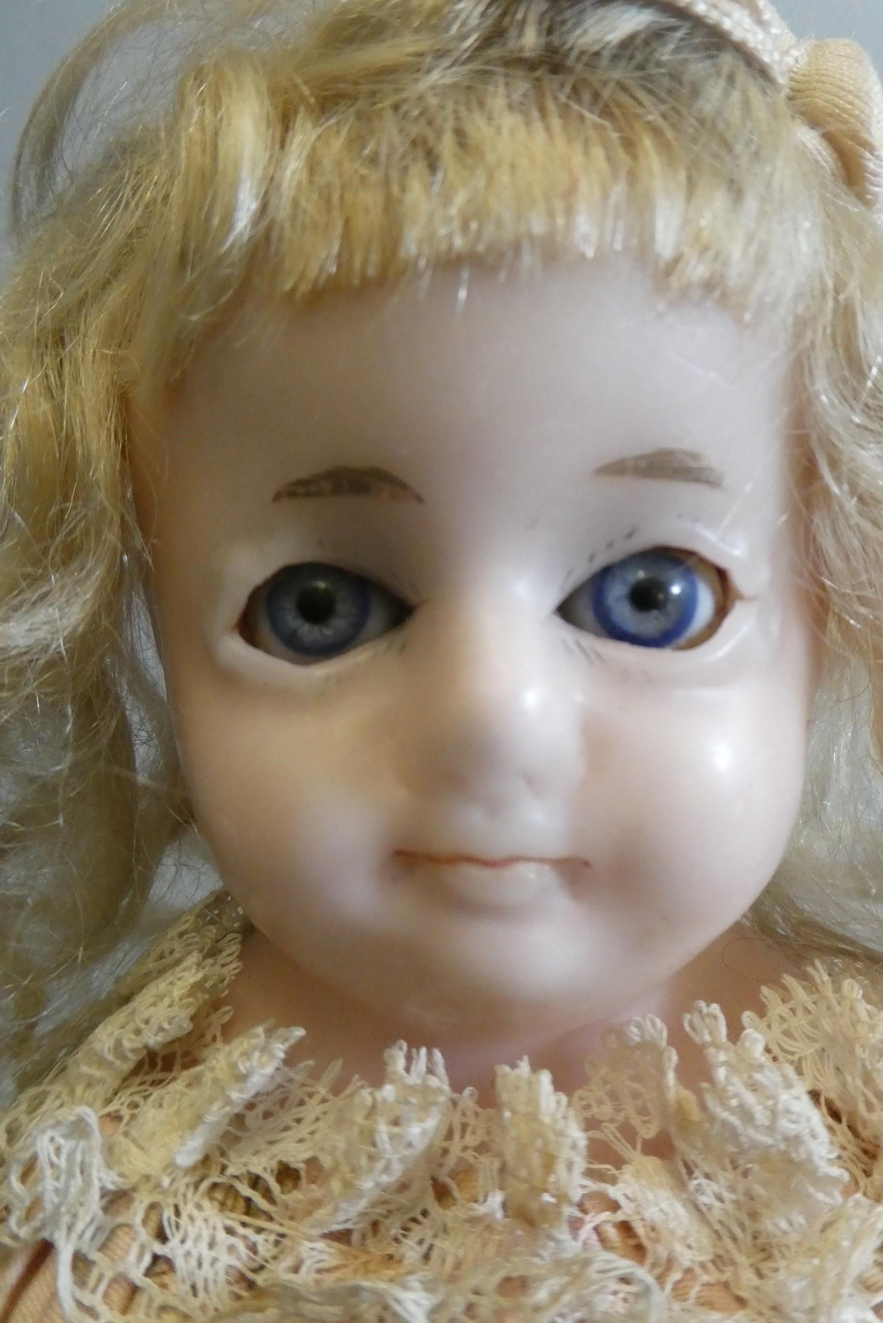 A Victorian wax shoulder head doll Image