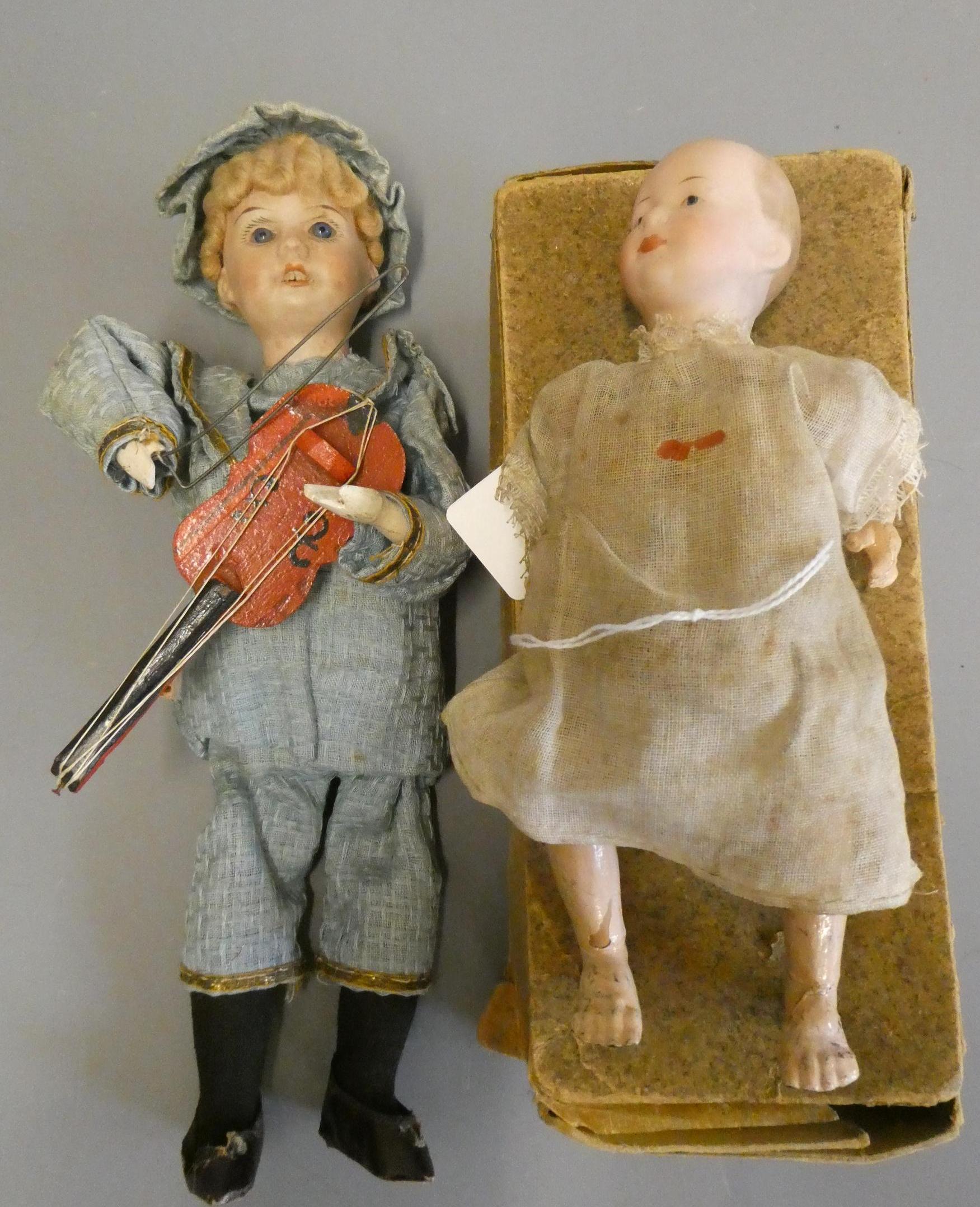 Two mechanical bisque head dolls Image