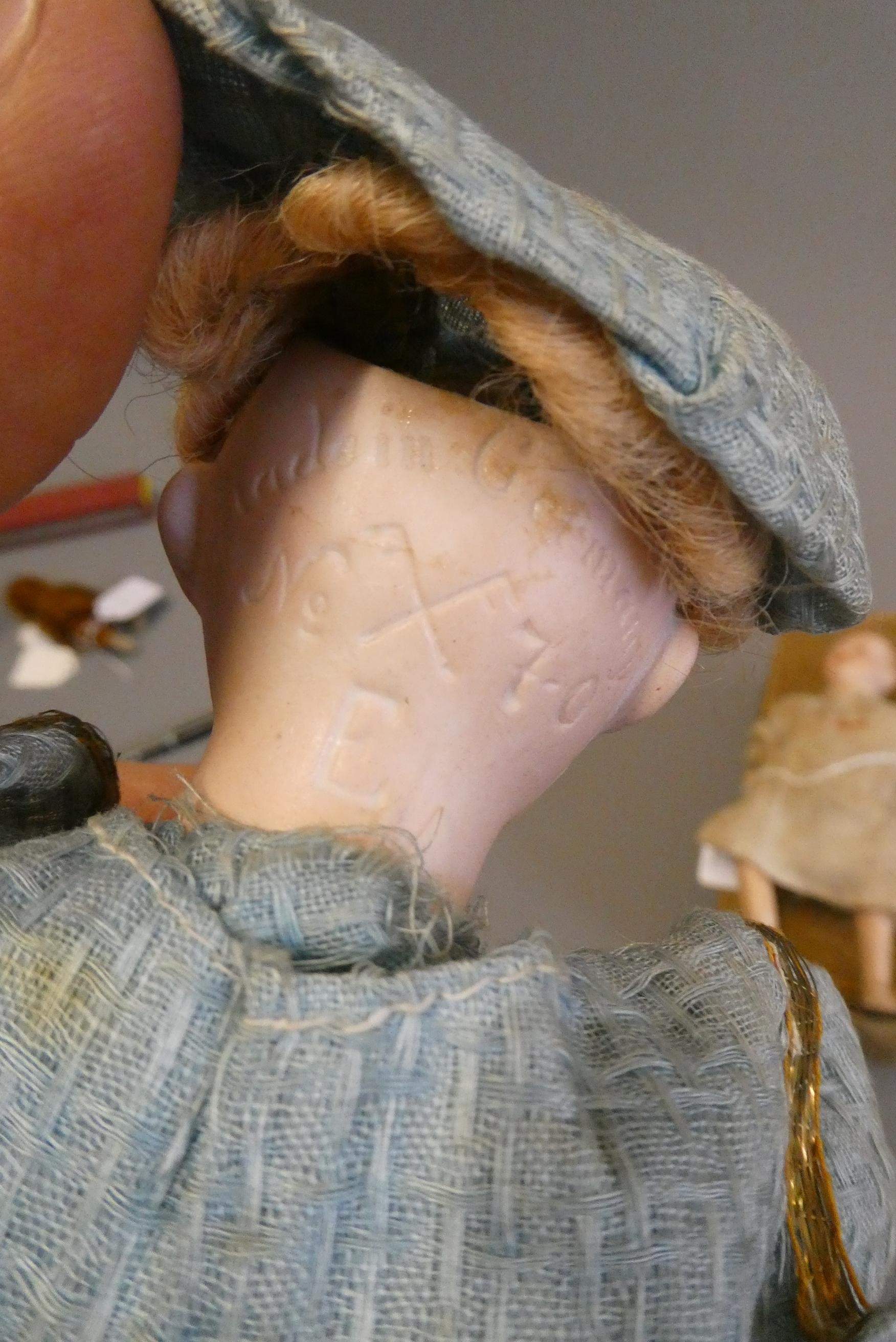 Two mechanical bisque head dolls Image