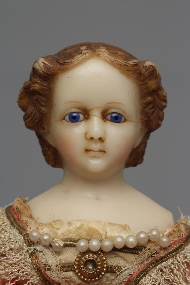 A Victorian wax shoulder head doll Image