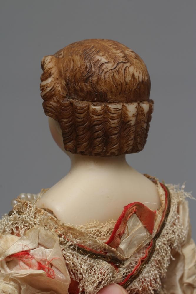 A Victorian wax shoulder head doll Image