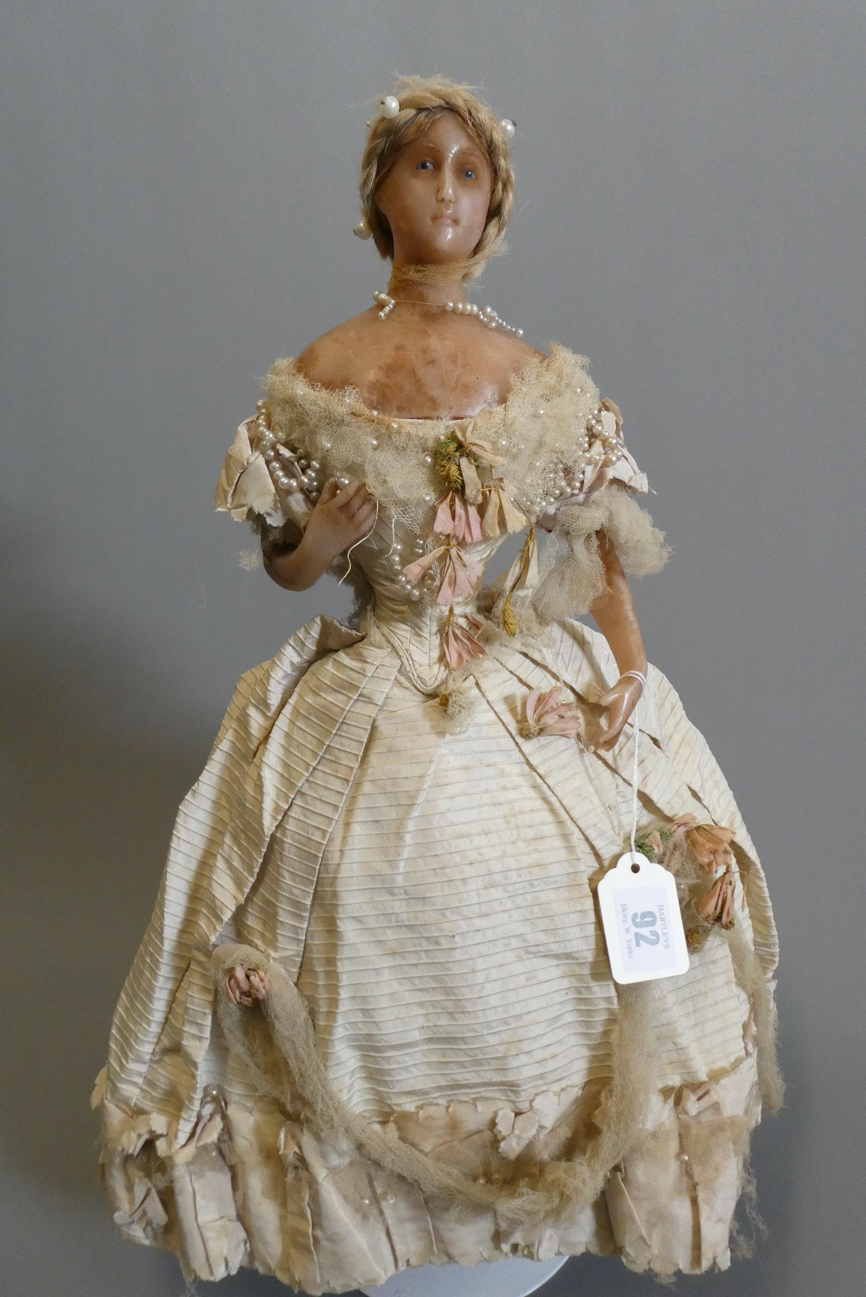 A Victorian wax shoulder head doll Image