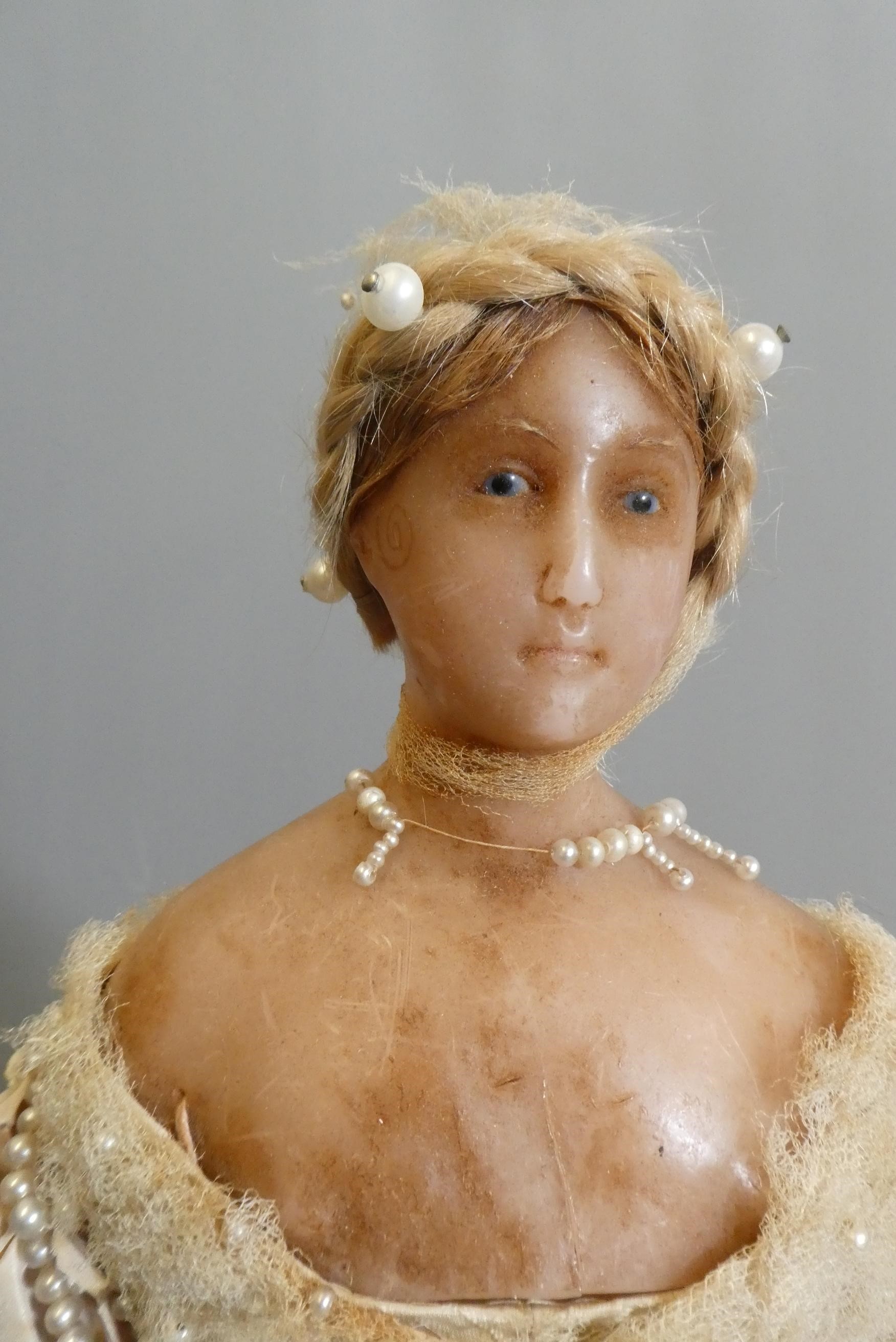 A Victorian wax shoulder head doll Image