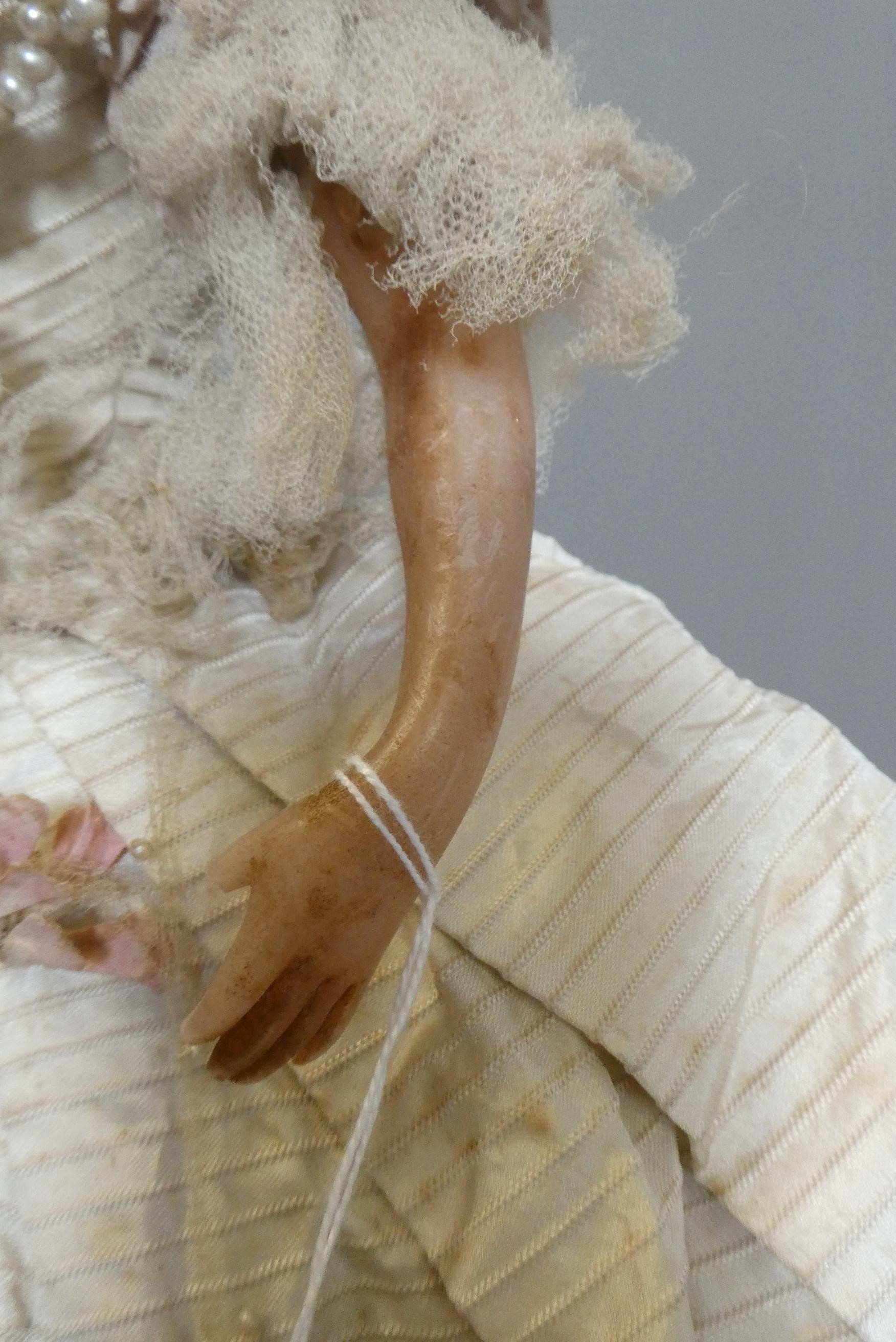 A Victorian wax shoulder head doll Image