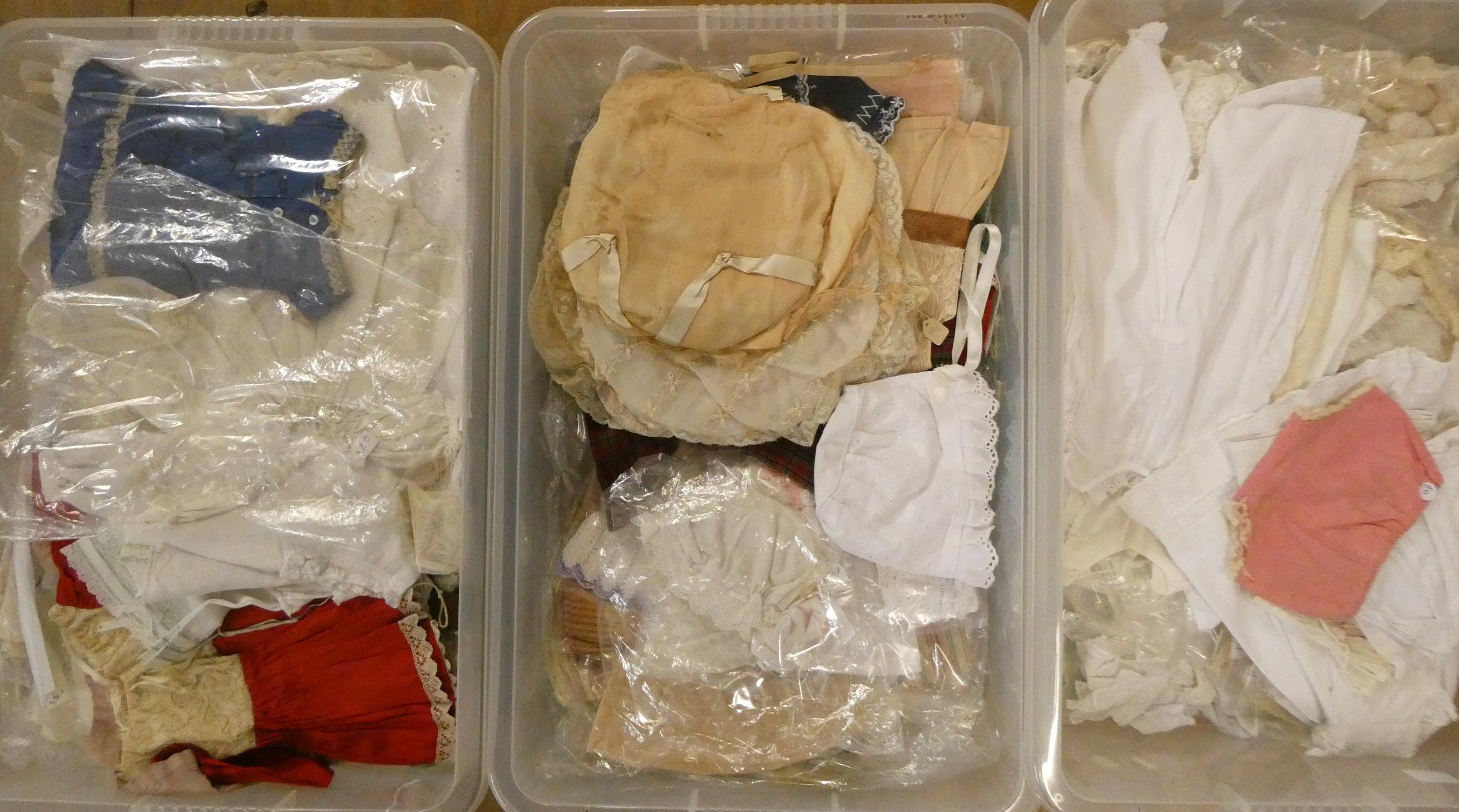 Three boxes of doll's clothing, including antique examples, lace, bonnets and much more (Est. plus Image