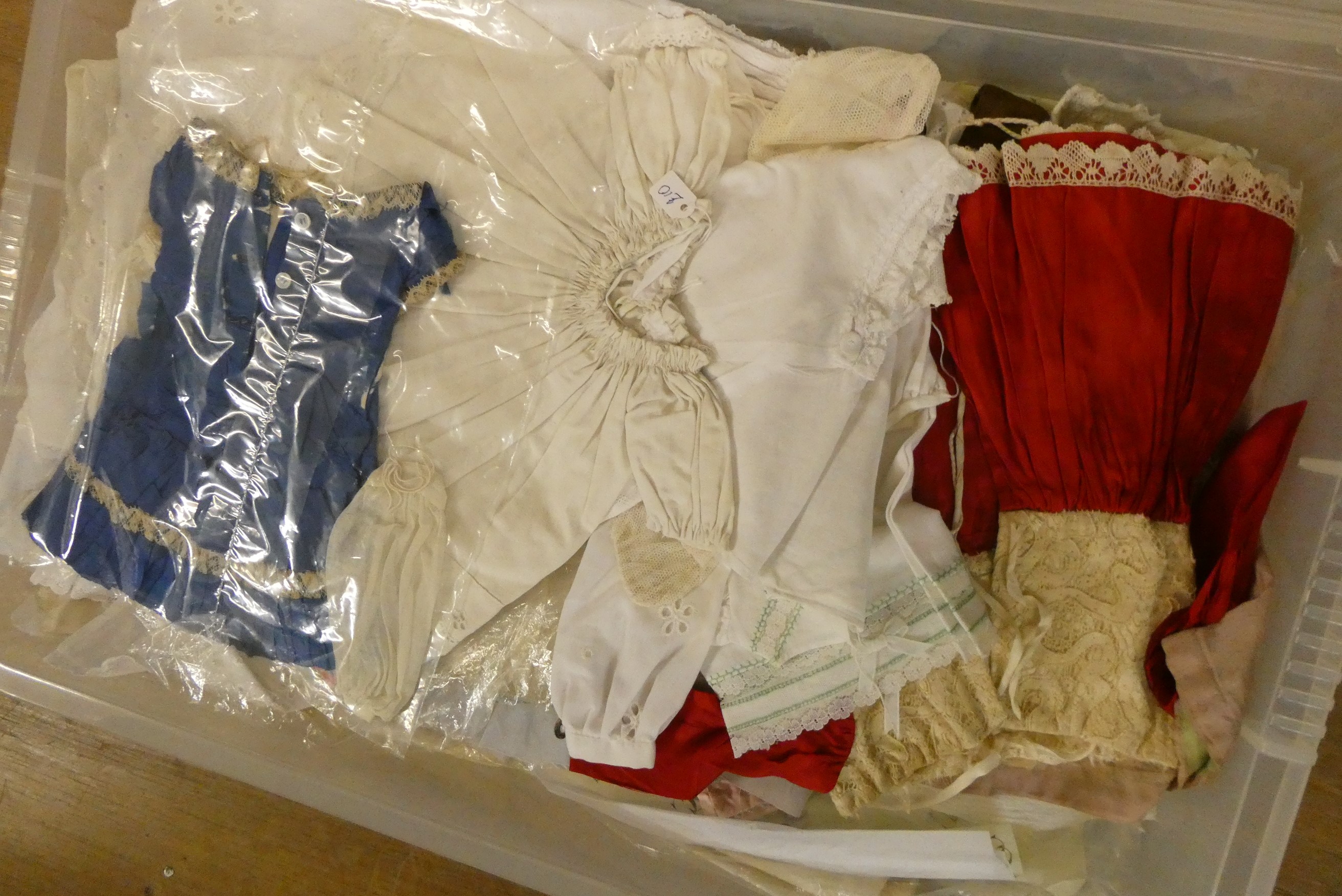 Three boxes of doll's clothing, including antique examples, lace, bonnets and much more (Est. plus Image