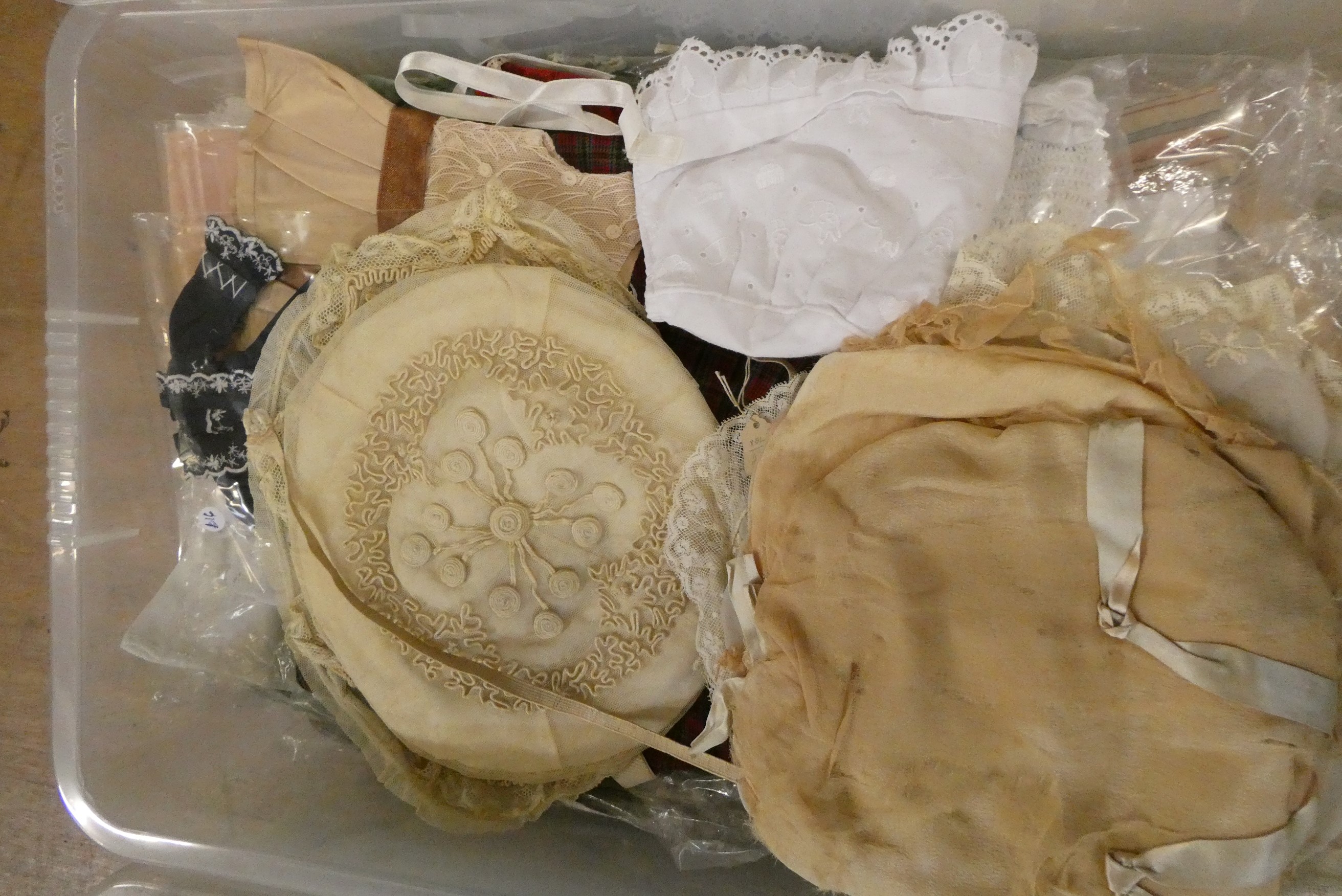 Three boxes of doll's clothing, including antique examples, lace, bonnets and much more (Est. plus Image