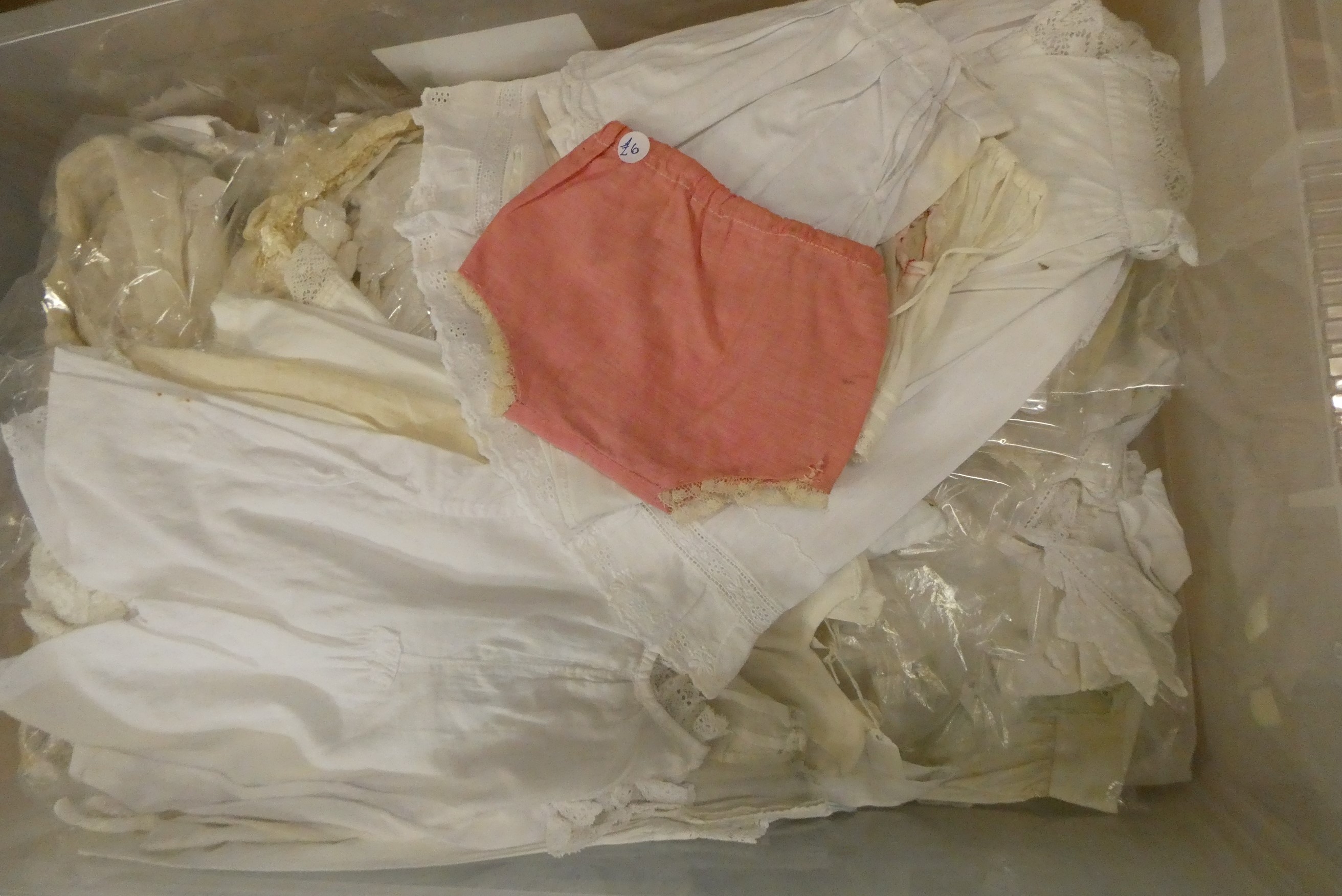 Three boxes of doll's clothing, including antique examples, lace, bonnets and much more (Est. plus Image
