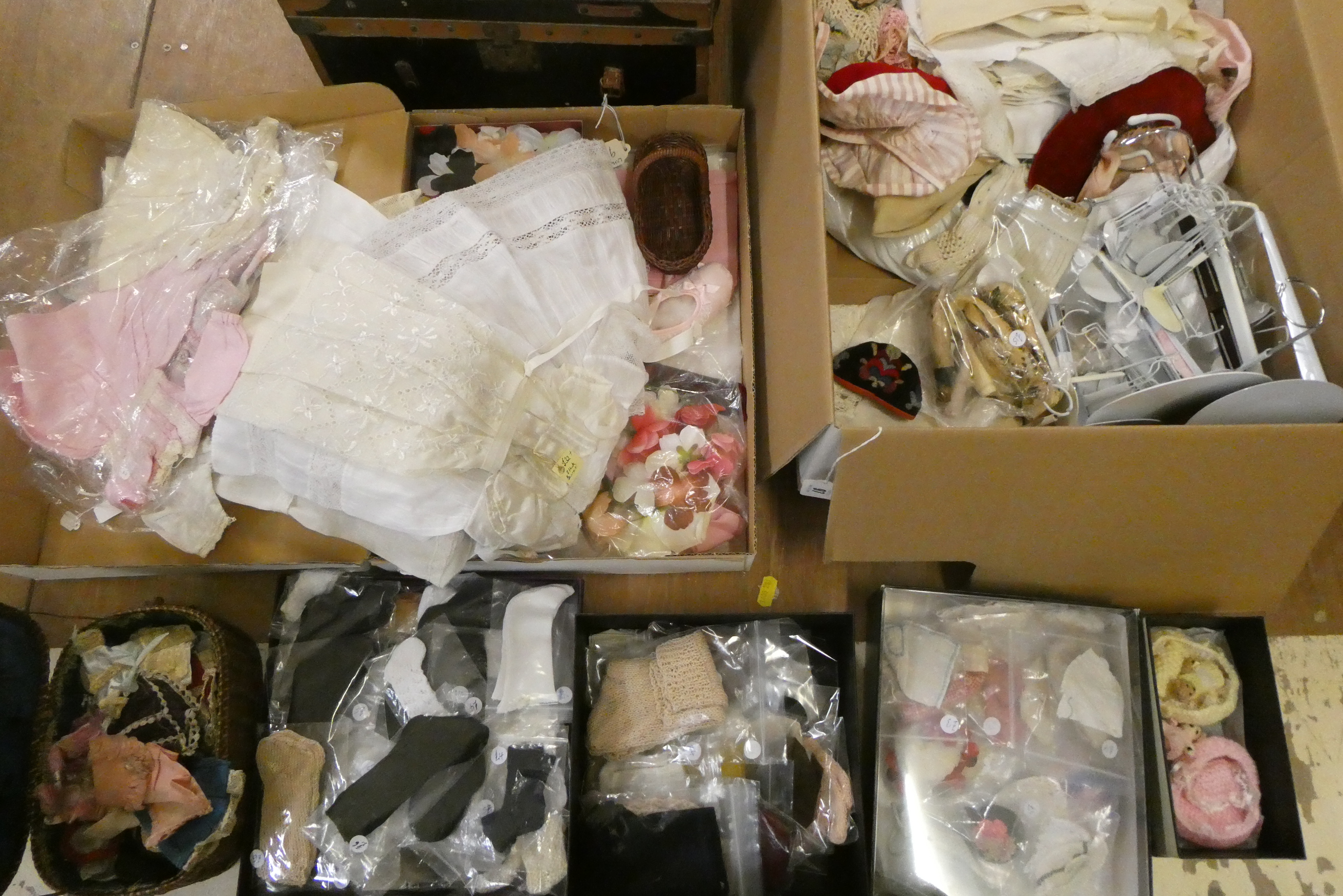 Two boxes of doll's clothing and accessories, together with doll stands and a trunk (Est. plus 24% Image