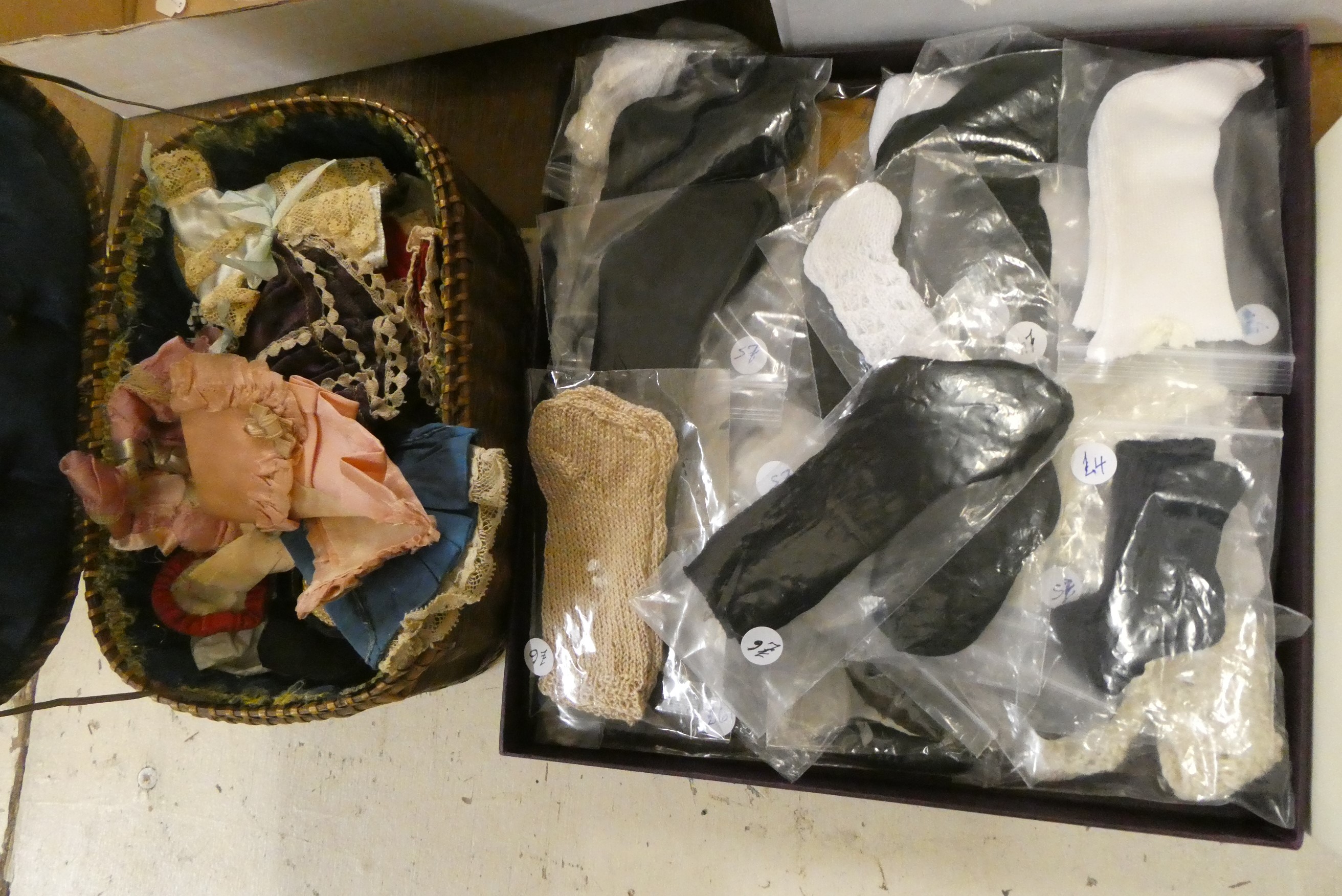Two boxes of doll's clothing and accessories, together with doll stands and a trunk (Est. plus 24% Image