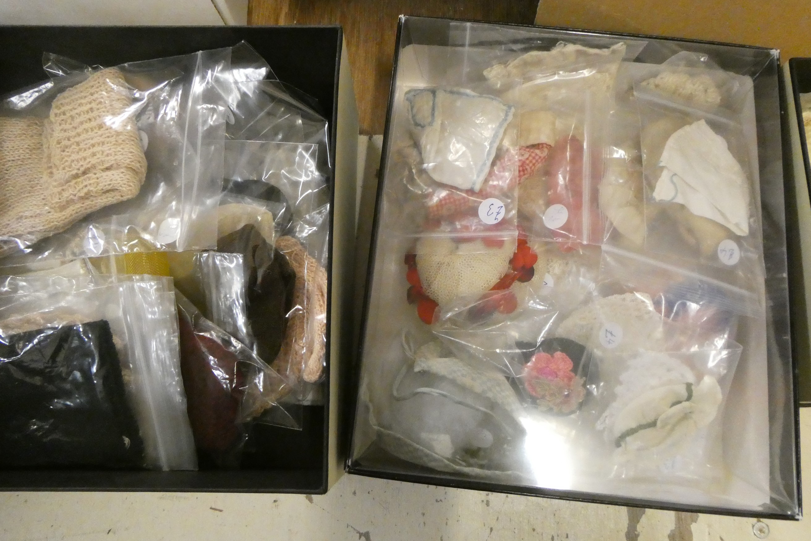 Two boxes of doll's clothing and accessories, together with doll stands and a trunk (Est. plus 24% Image