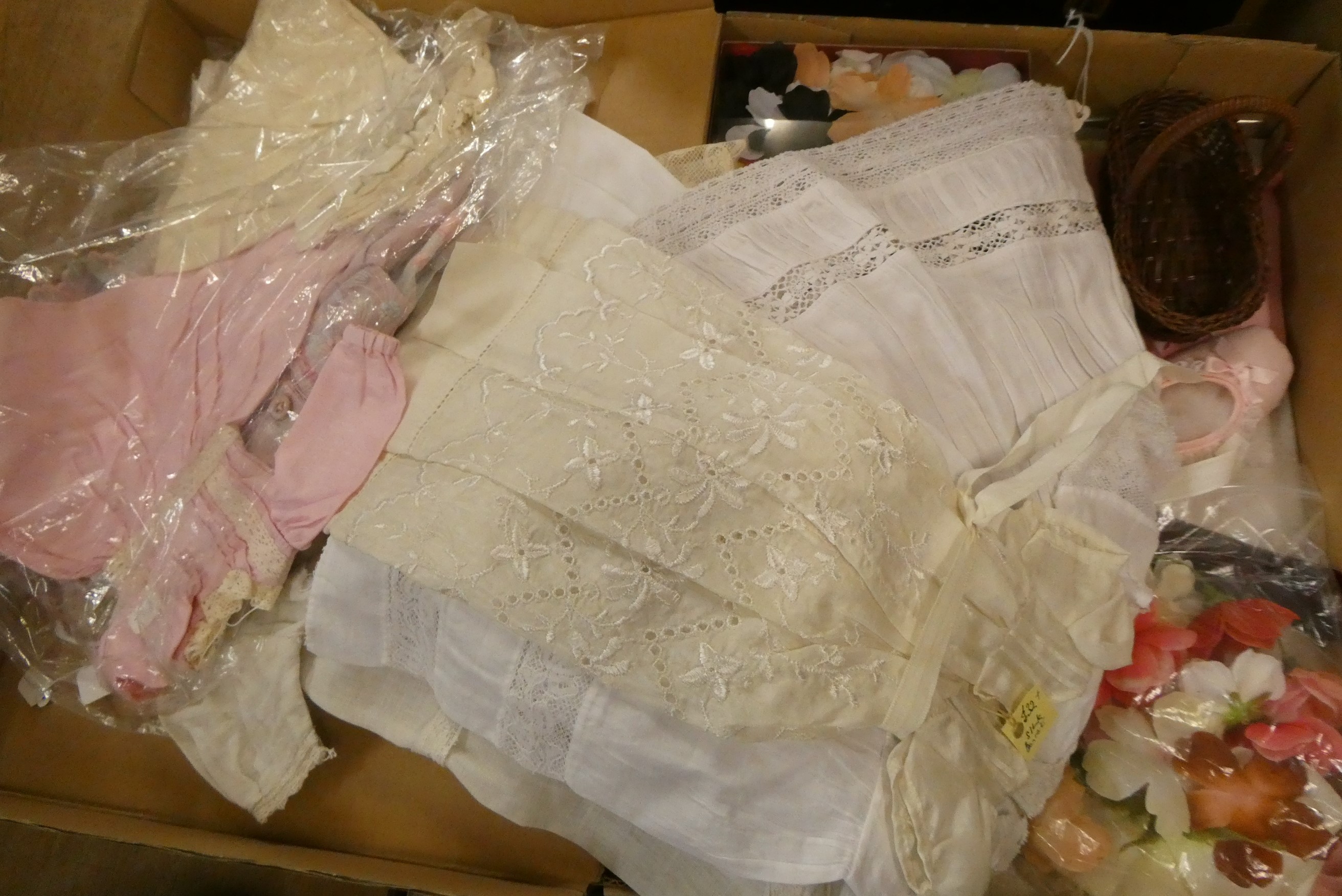 Two boxes of doll's clothing and accessories, together with doll stands and a trunk (Est. plus 24% Image