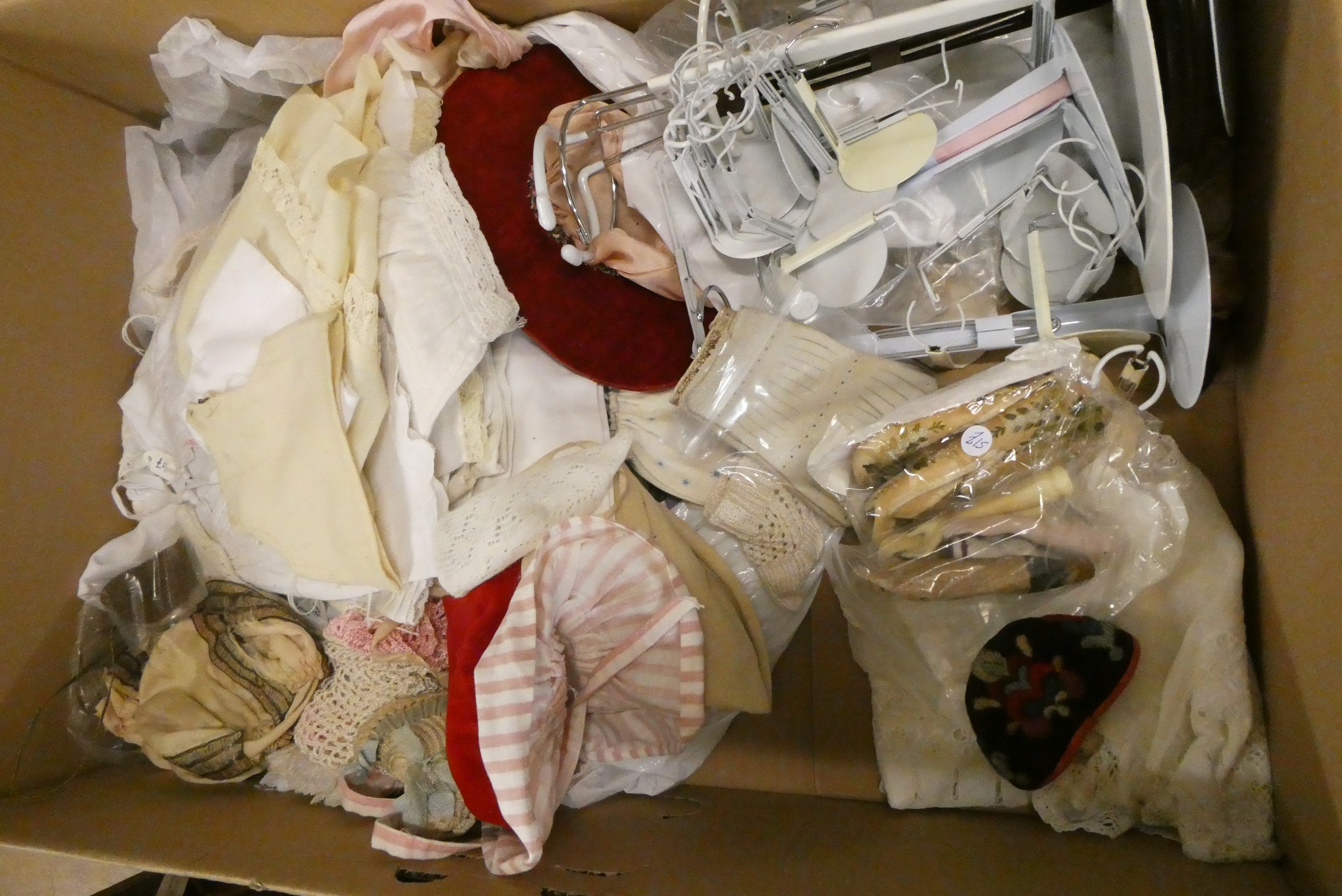 Two boxes of doll's clothing and accessories, together with doll stands and a trunk (Est. plus 24% Image