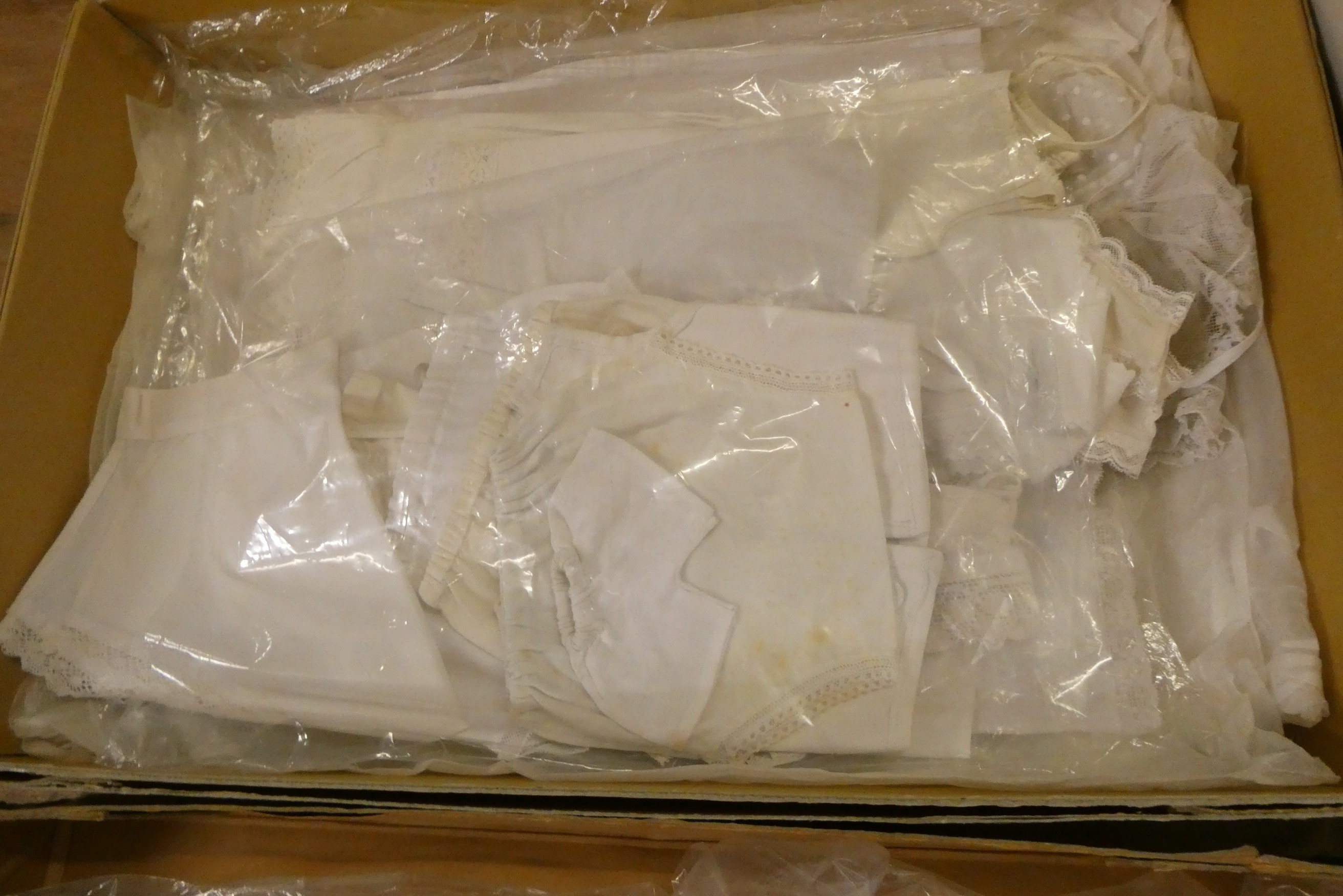 Four boxes of doll's antique and later clothing (Est. plus 24% buyer's premium inc. VAT) Image