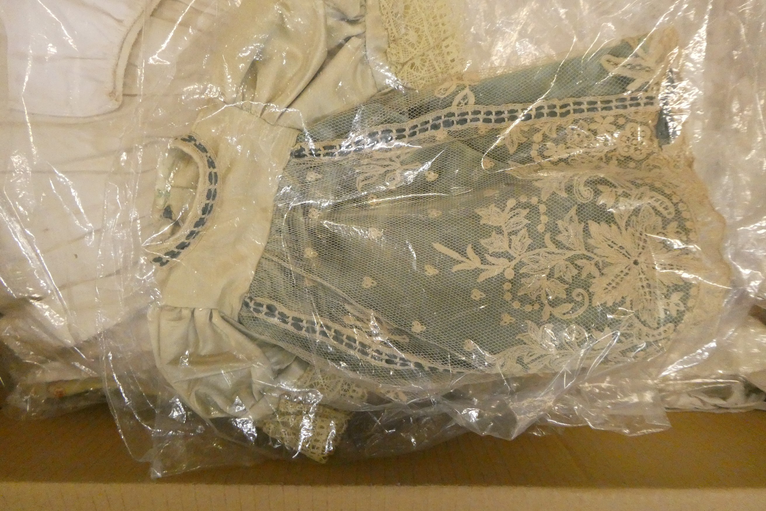 Four boxes of doll's antique and later clothing (Est. plus 24% buyer's premium inc. VAT) Image