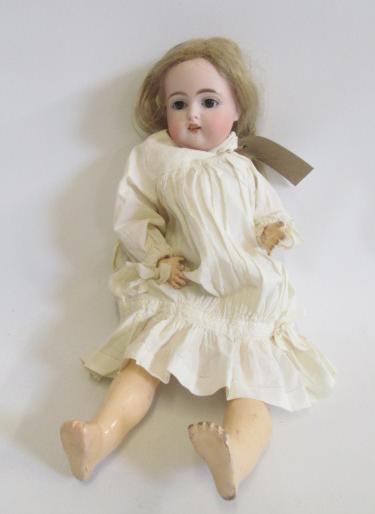 A Kammer & Reinhardt bisque head doll with brown glass sleeping eyes Image
