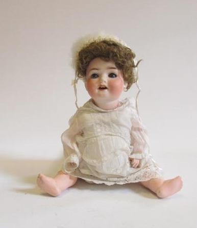 An Ernst Heubach bisque head character doll with blue glass sleeping eyes Image