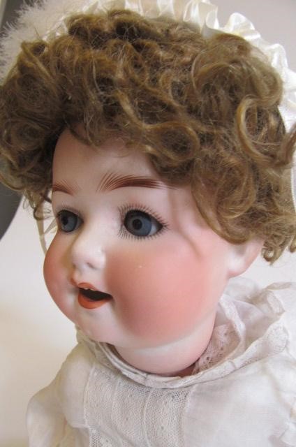 An Ernst Heubach bisque head character doll with blue glass sleeping eyes Image