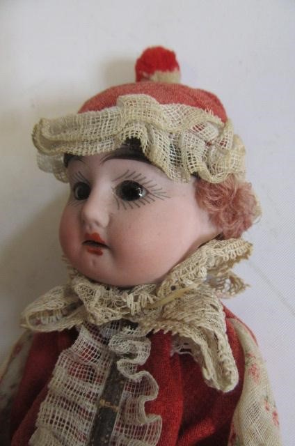 A cymbals doll with bisque head Image