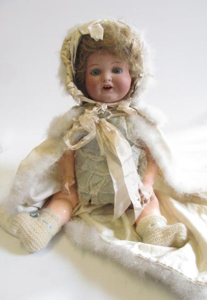 An Armand Marseille bisque head character doll with blue glass sleeping eyes Image