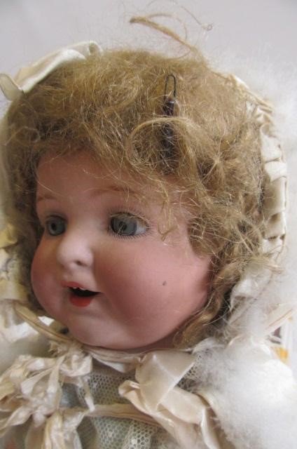 An Armand Marseille bisque head character doll with blue glass sleeping eyes Image