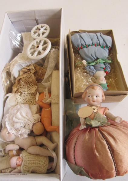 A bisque pin cushion doll with swivel arms Image