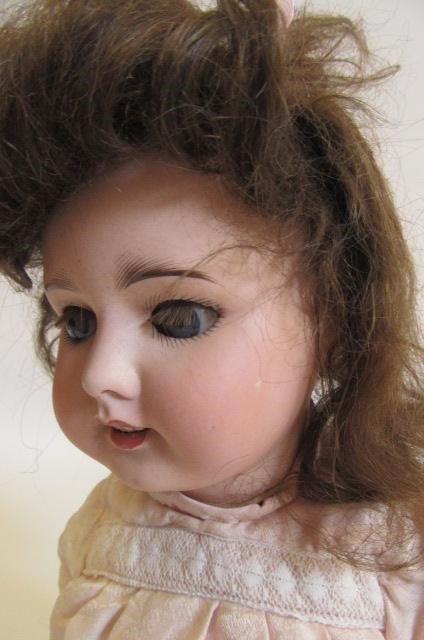 An S.F.B.J. bisque head doll with blue glass sleeping eyes Image