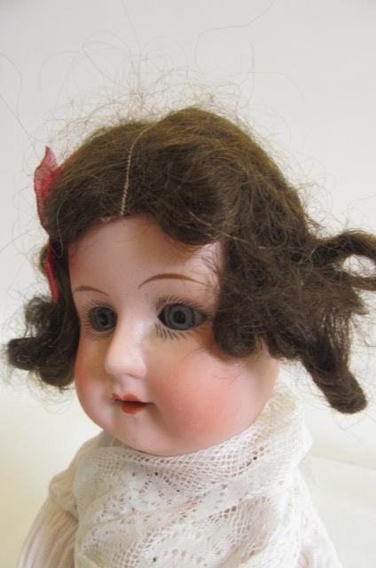 A J. Walther & Sohn bisque head doll with blue glass sleeping eyes Image