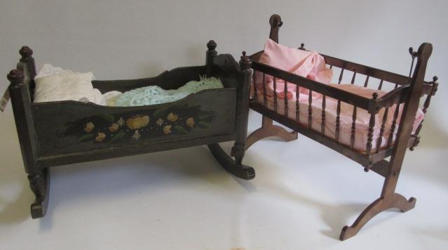 A doll's painted wood cradle Image