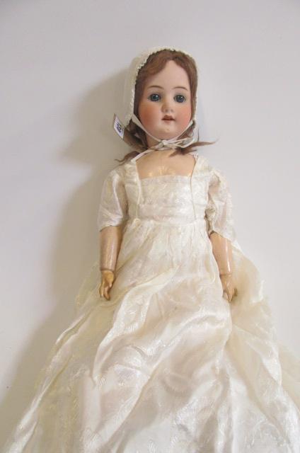 An Ernst Heubach bisque head doll with blue glass sleeping eyes Image