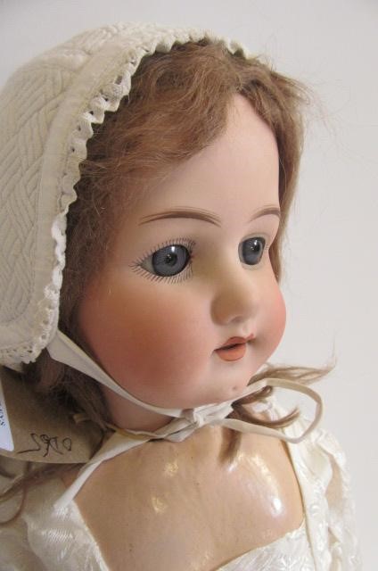 An Ernst Heubach bisque head doll with blue glass sleeping eyes Image
