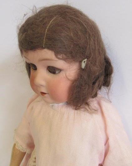 A Gebruder Heubach bisque head doll with brown glass sleeping eyes Image