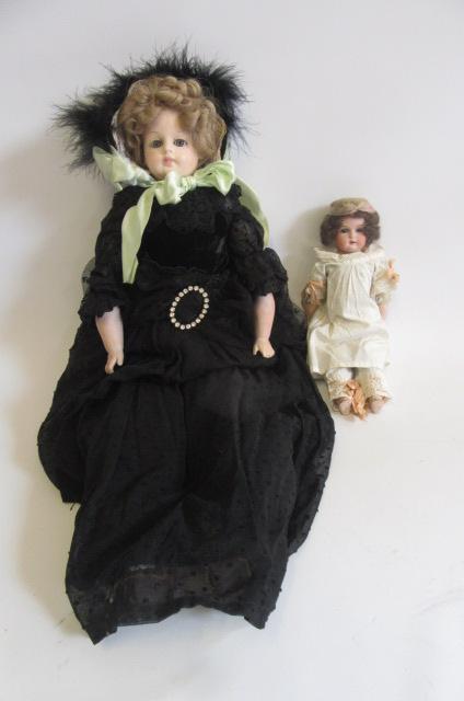 A composition shoulder head doll with fixed blue glass eyes Image