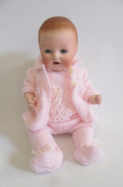 An Ernst Heubach bisque head doll with blue glass sleeping eyes Image