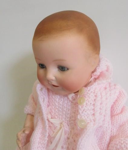 An Ernst Heubach bisque head doll with blue glass sleeping eyes Image