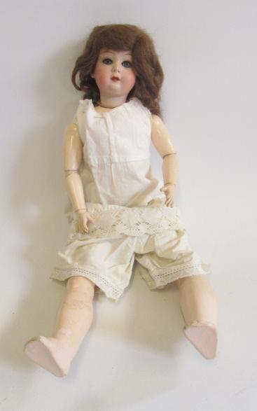 A Gebruder Heubach bisque head doll with blue glass sleeping eyes Image