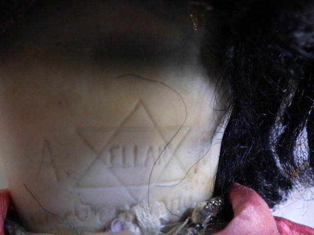 An Armand Marseille bisque socket head Oriental doll with brown glass sleeping eyes and painted face Image