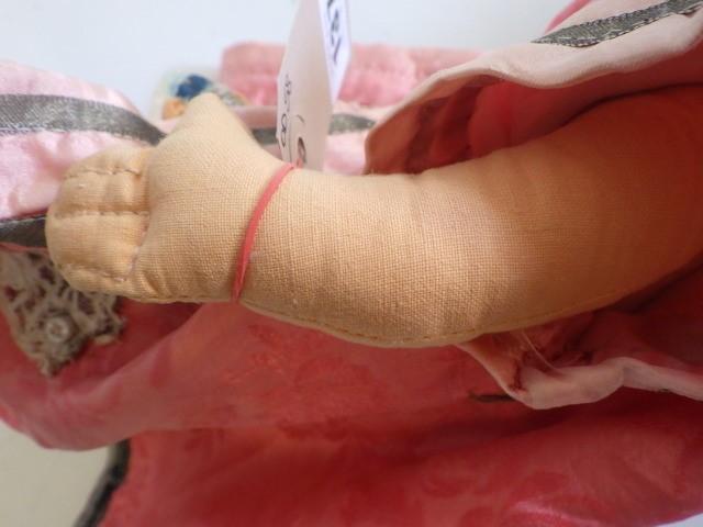 An Armand Marseille bisque socket head Oriental doll with brown glass sleeping eyes and painted face Image