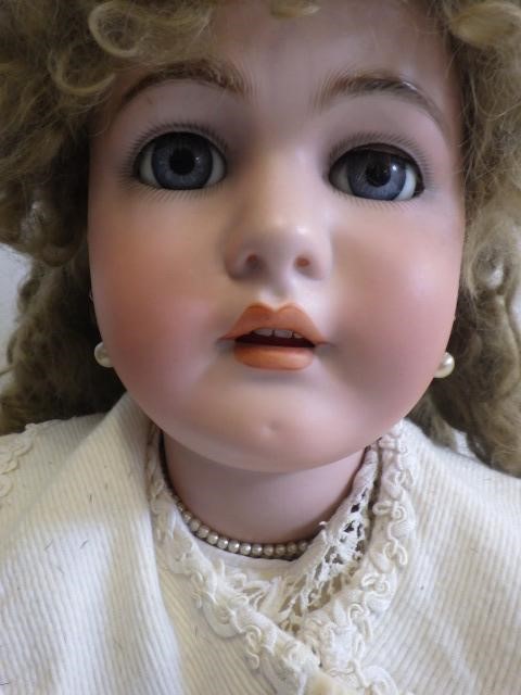 A large Simon & Halbig K & R bisque socket head doll with blue glass sleeping eyes Image
